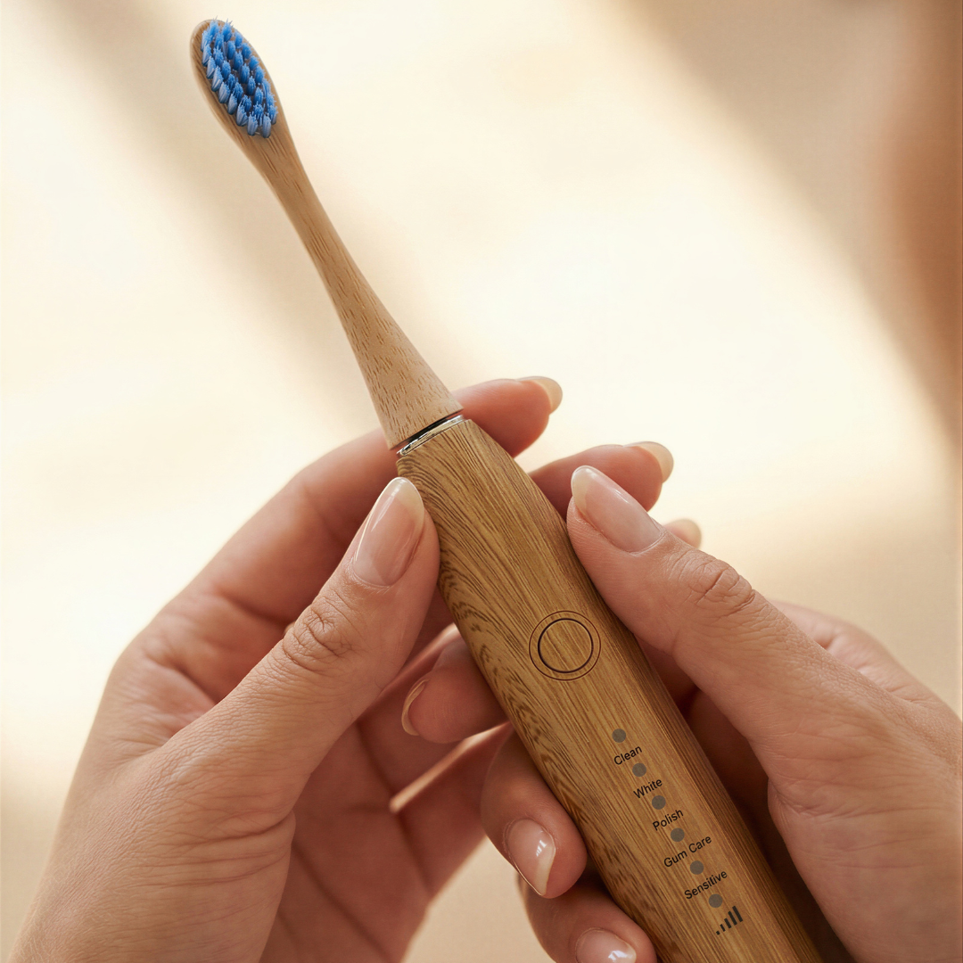 bamboo electric toothbrush held in hand close-up showing natural grip